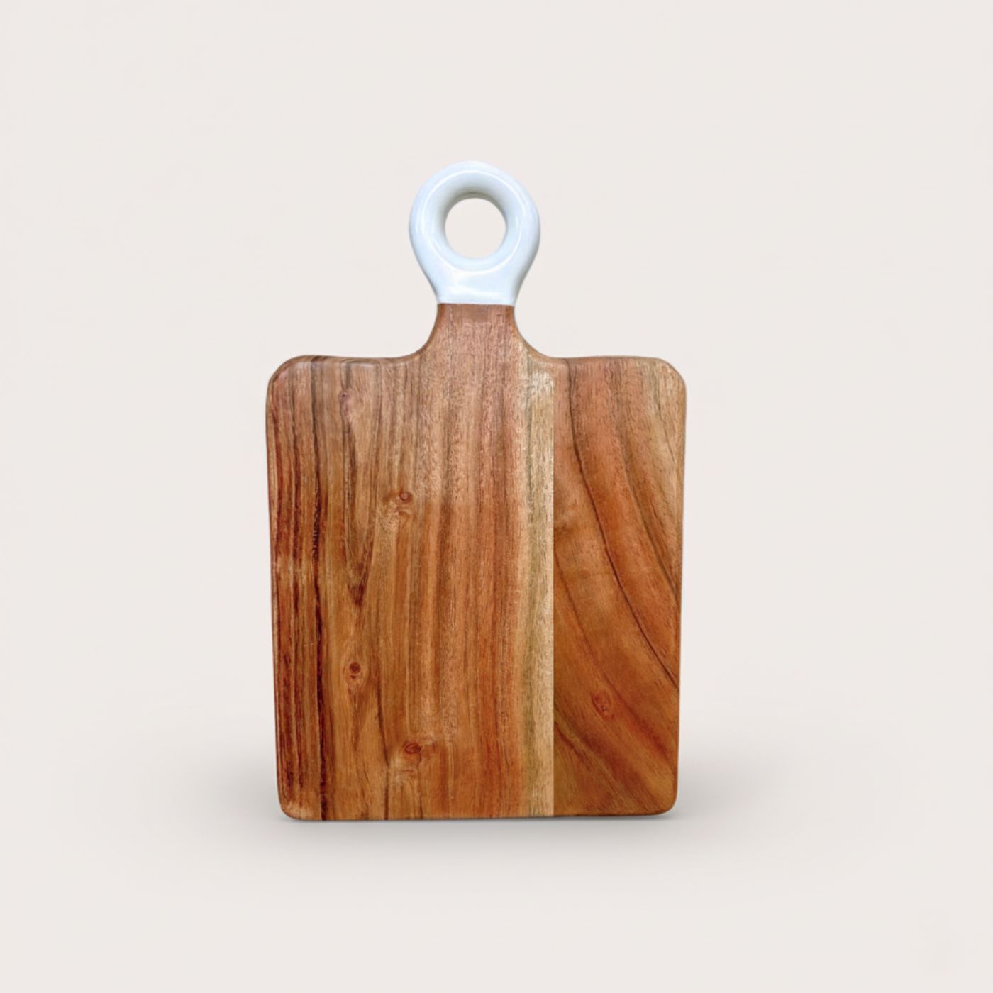 Wooden cutting board with a white handle on a light beige background