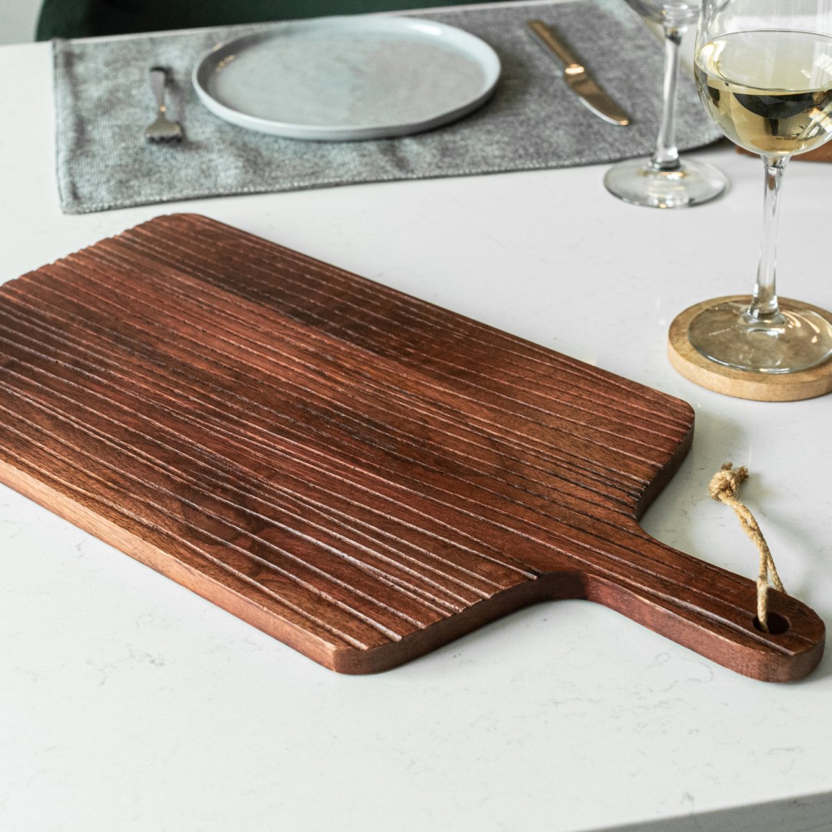 Large wooden board with engraved lines_on island with decor - Aesthetic Living