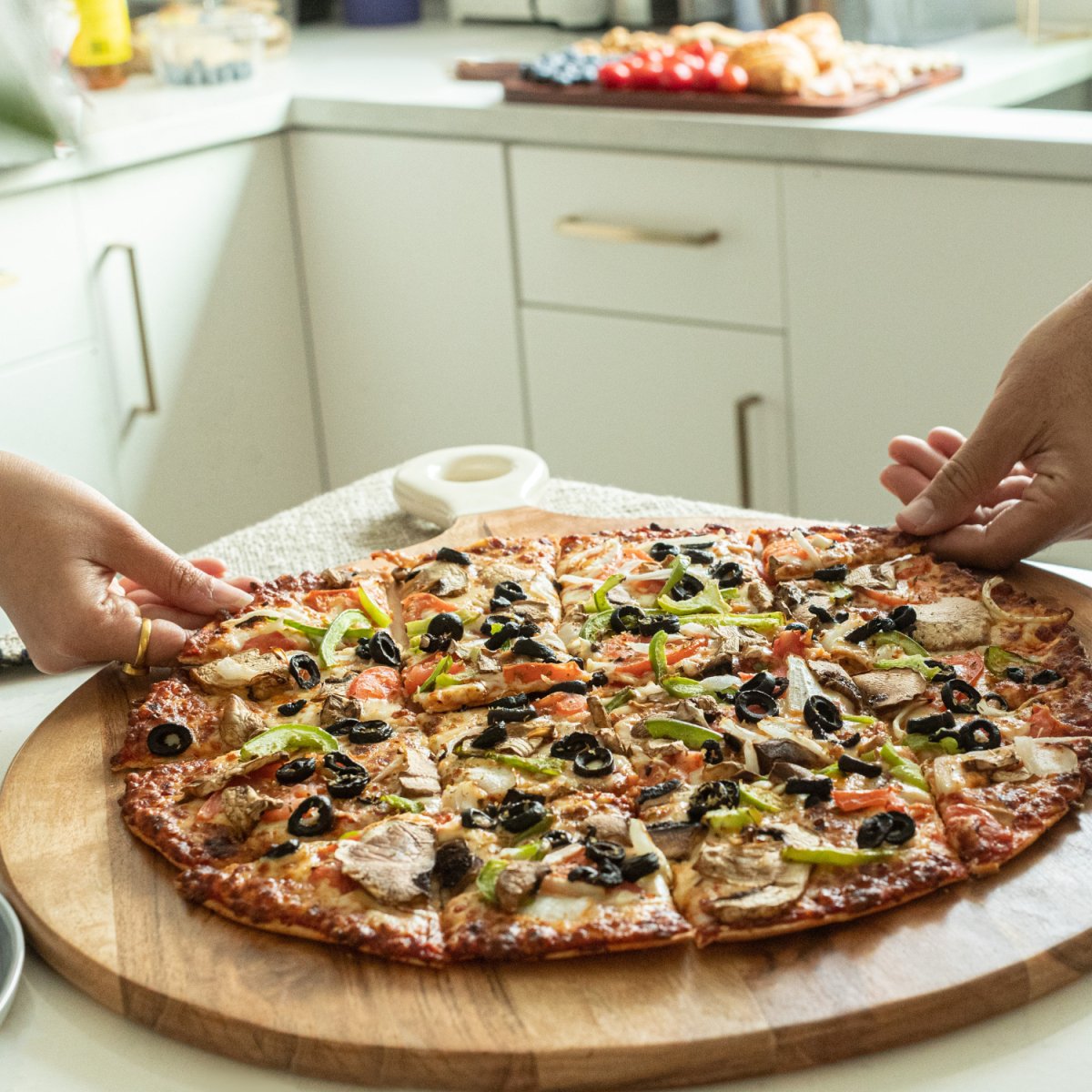 Pizza Peel Shaped Round Pizza Paddle Charcuterie Board with White Enamel Handles lifestyle image- Aesthetic Living