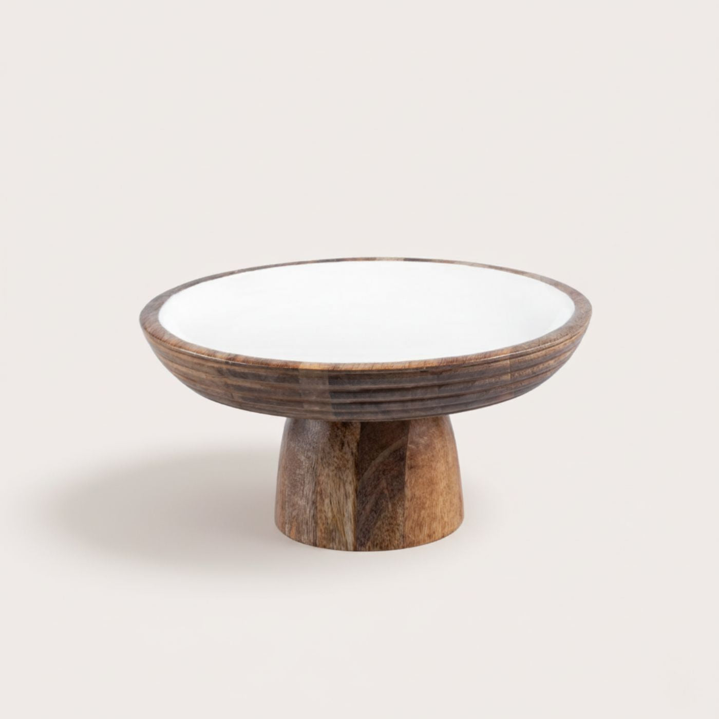 Wooden cake stand with enamel base on a light background
