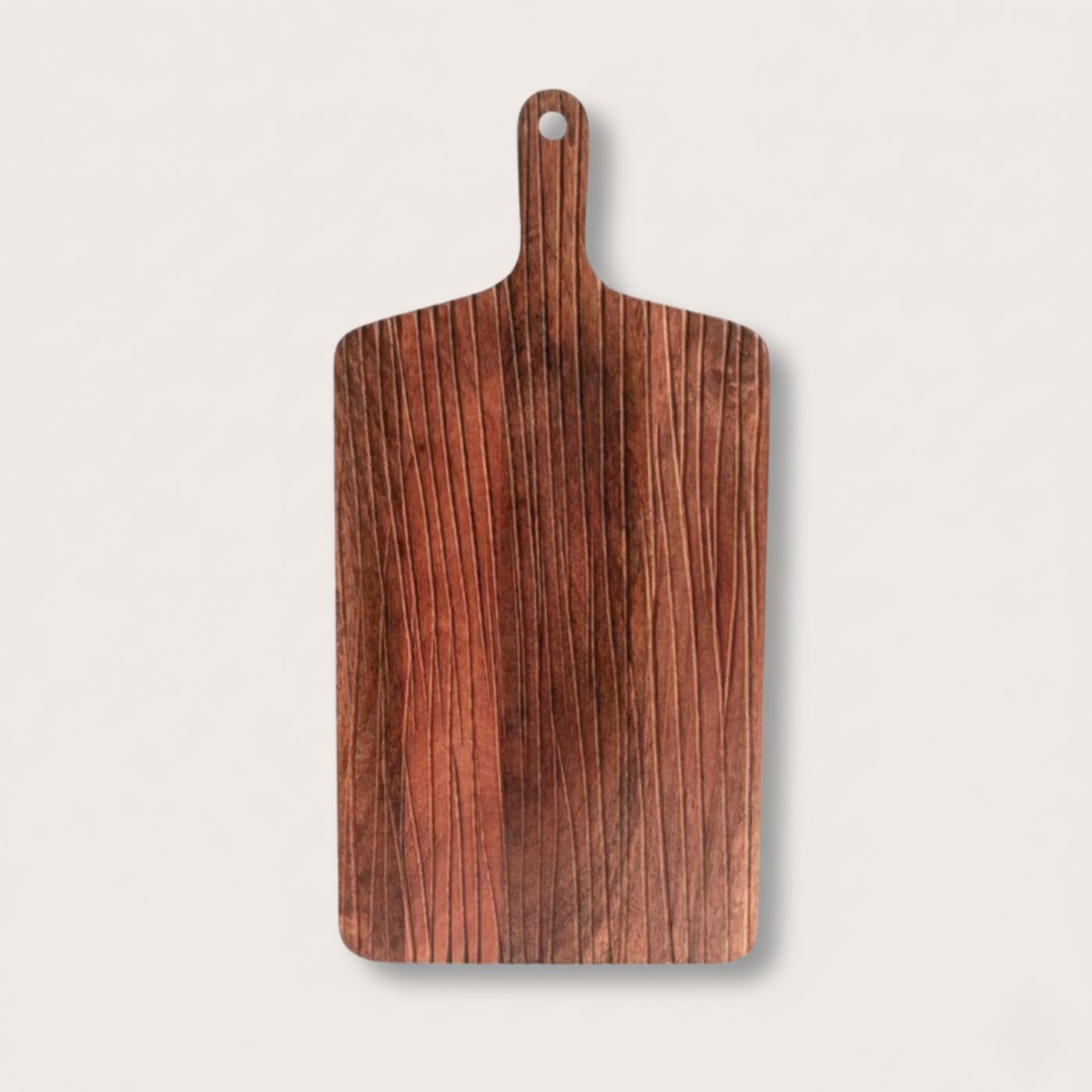 Large dual sided wooden cutting board with a handle on a light gray background
