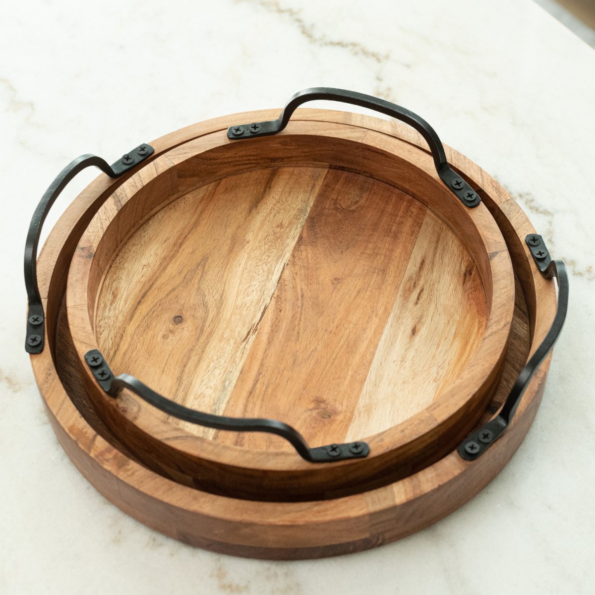 Round Wooden Serving Trays with Black Metal Handles, set of 2 nesting into each other image - Aesthetic Living